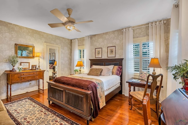 603 E Melton, Longview, TX 75602 - bedroom with wallpapered walls, multiple windows, wood finished floors, and ceiling fan