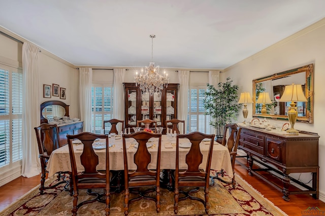 603 E Melton, Longview, TX 75602 - dining room featuring a chandelier, healthy amount of natural light, crown molding, and wood finished floors