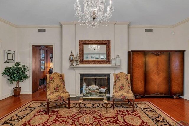603 E Melton, Longview, TX 75602 - sitting room featuring wood finished floors, a chandelier, ornamental molding, a high end fireplace, and baseboards