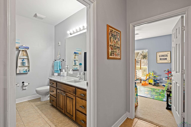 bathroom featuring tile patterned flooring, vanity, and toilet