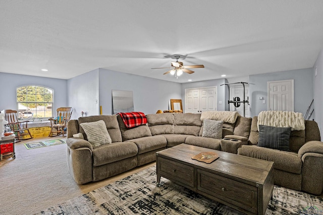 living room with light carpet and ceiling fan