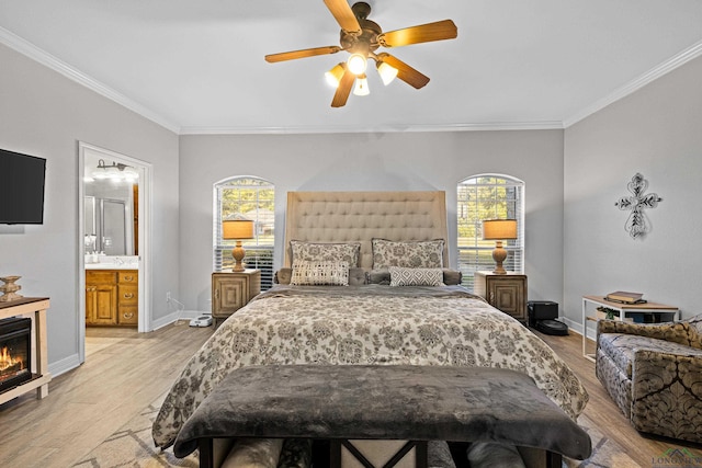 bedroom featuring ensuite bath, ceiling fan, crown molding, and light hardwood / wood-style floors