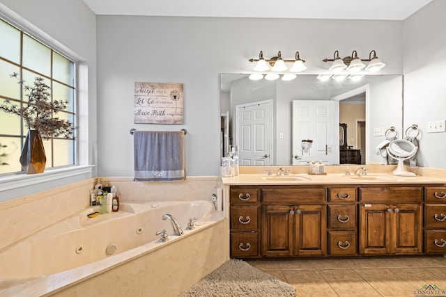 bathroom featuring tile patterned flooring, vanity, and a bath