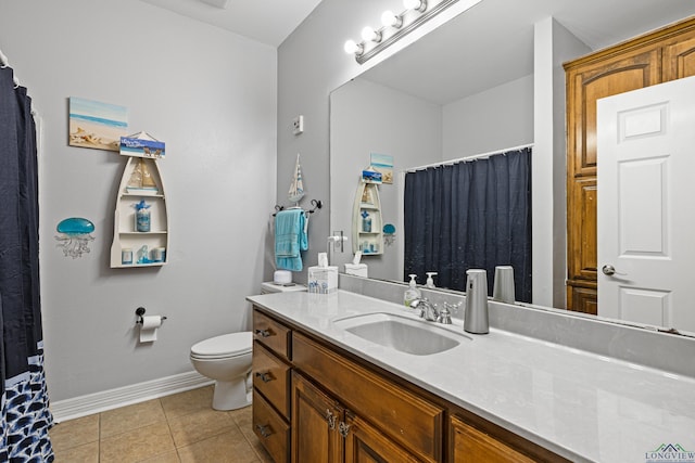 bathroom featuring tile patterned floors, vanity, and toilet