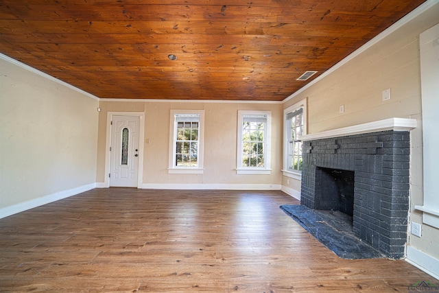 unfurnished living room with lofted ceiling, wooden ceiling, a brick fireplace, ornamental molding, and wood-type flooring