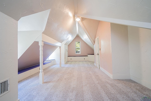 bonus room featuring carpet floors and vaulted ceiling