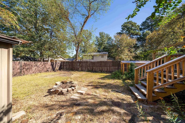 view of yard with an outdoor fire pit