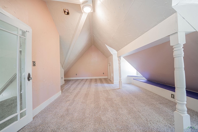 bonus room with carpet flooring and vaulted ceiling