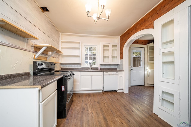 kitchen featuring an inviting chandelier, white dishwasher, black range with electric stovetop, hanging light fixtures, and white cabinetry