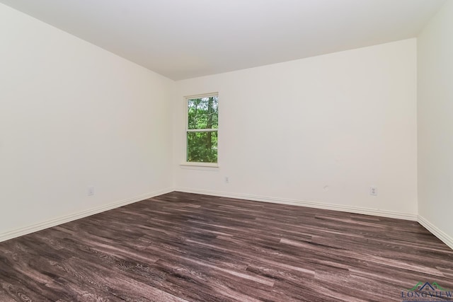 1205 Booker St, Longview, TX 75602 - spare room with dark wood finished floors