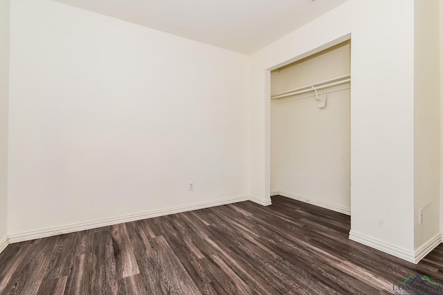 1205 Booker St, Longview, TX 75602 - unfurnished bedroom with dark wood-style flooring and a closet
