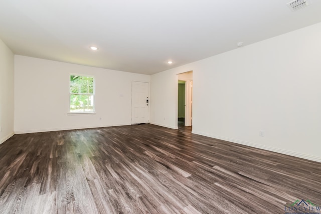 1205 Booker St, Longview, TX 75602 - unfurnished room with dark wood-style flooring and recessed lighting