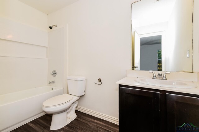 1205 Booker St, Longview, TX 75602 - full bath featuring vanity, wood finished floors, and tub / shower combination