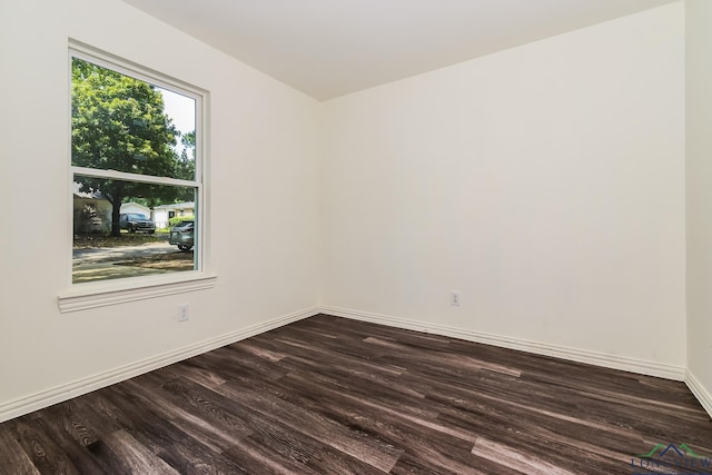 1205 Booker St, Longview, TX 75602 - spare room with dark wood-style flooring and baseboards