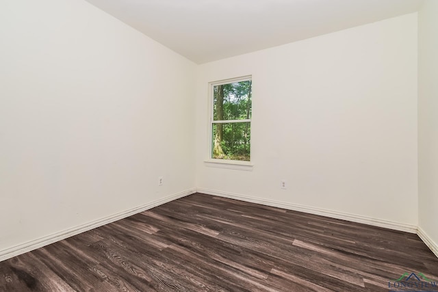 1205 Booker St, Longview, TX 75602 - unfurnished room featuring dark wood-type flooring and lofted ceiling