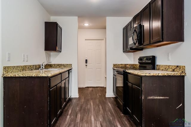 1205 Booker St, Longview, TX 75602 - kitchen with black appliances, dark wood-style floors, dark brown cabinetry, and light stone counters