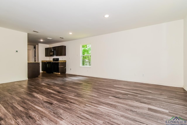 1205 Booker St, Longview, TX 75602 - unfurnished living room with dark wood-style flooring and recessed lighting