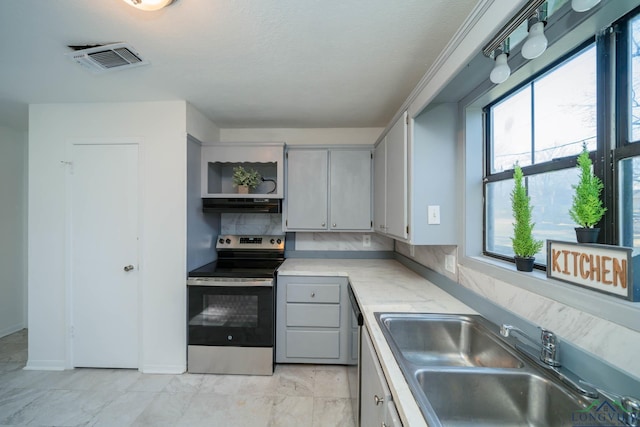 kitchen with decorative backsplash, electric stove, gray cabinetry, and sink