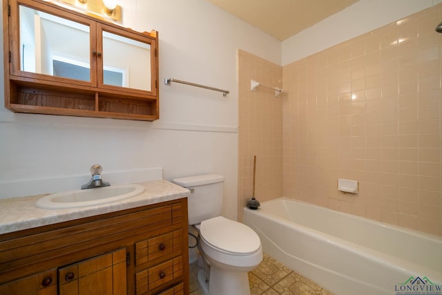 full bathroom with toilet, vanity, and tiled shower / bath combo