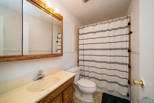 bathroom with a textured ceiling, toilet, walk in shower, and vanity