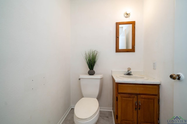 bathroom with toilet and vanity