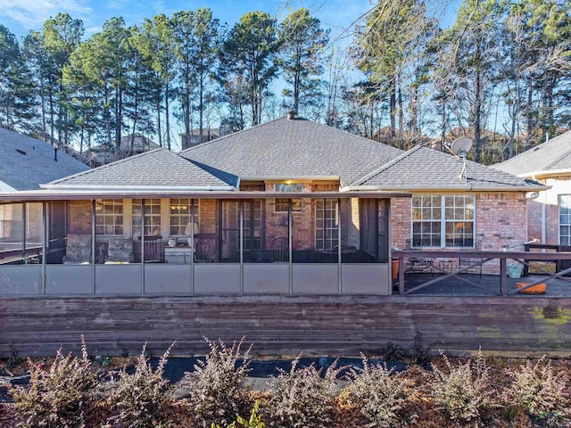 rear view of property with a sunroom