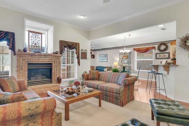 living room with carpet floors, an inviting chandelier, ornamental molding, and a fireplace