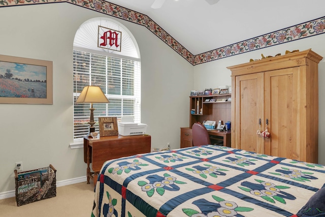 carpeted bedroom featuring ceiling fan and vaulted ceiling