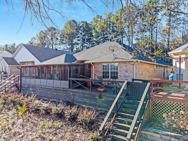 back of house featuring a deck and a sunroom