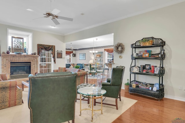 living room featuring a brick fireplace, crown molding, hardwood / wood-style flooring, and ceiling fan