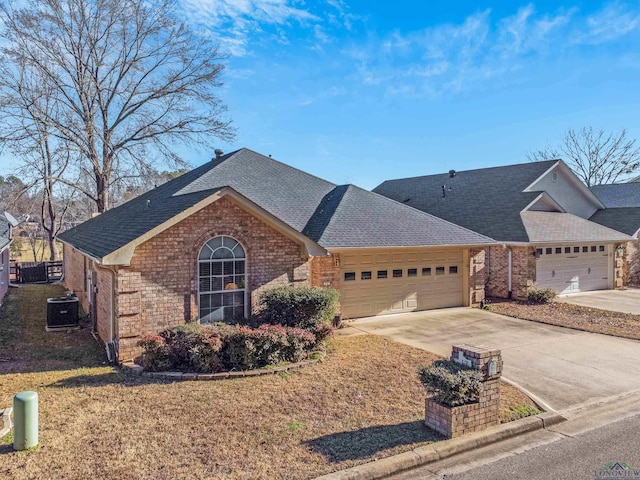 single story home with a garage and cooling unit