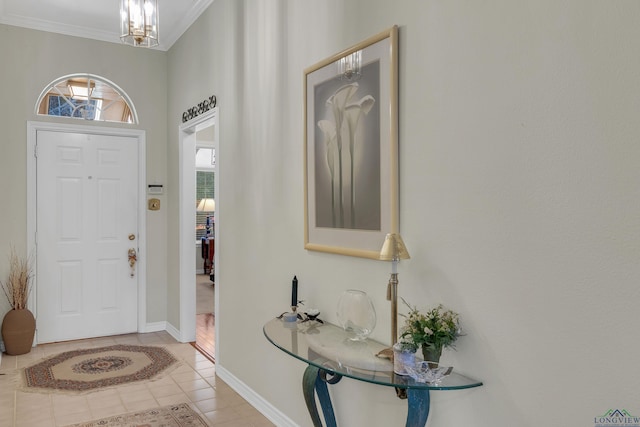 foyer featuring light tile patterned flooring, crown molding, and a notable chandelier