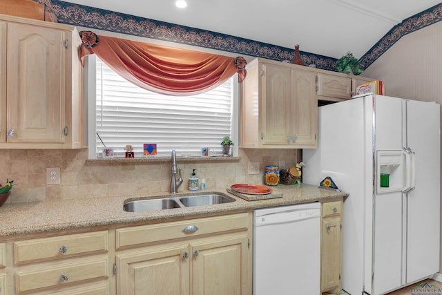 kitchen featuring light brown cabinets, sink, and white appliances