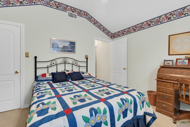 carpeted bedroom featuring lofted ceiling