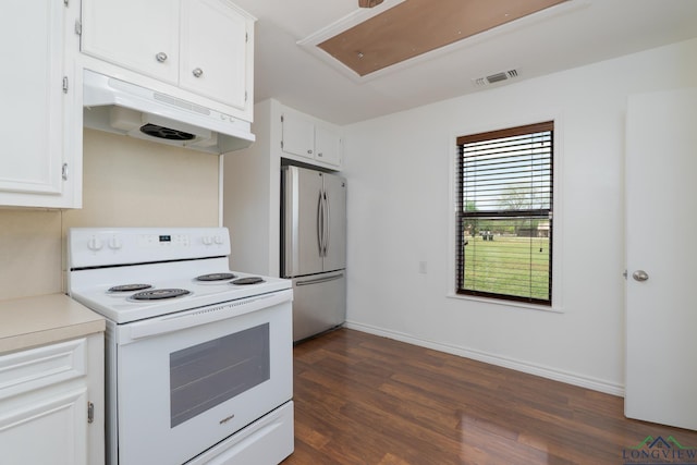 809 Turner Ln, Tuscola, TX 79562 - kitchen with electric range, freestanding refrigerator, under cabinet range hood, dark wood-style floors, and white cabinetry