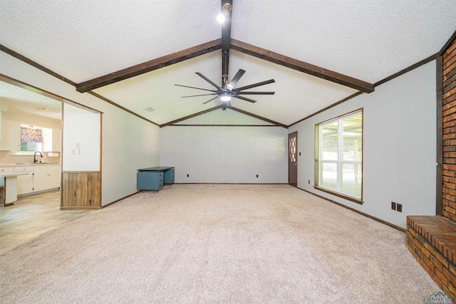 4525 Surratt Rd, Longview, TX 75604 - unfurnished living room with light colored carpet, a ceiling fan, a textured ceiling, a sink, and ornamental molding