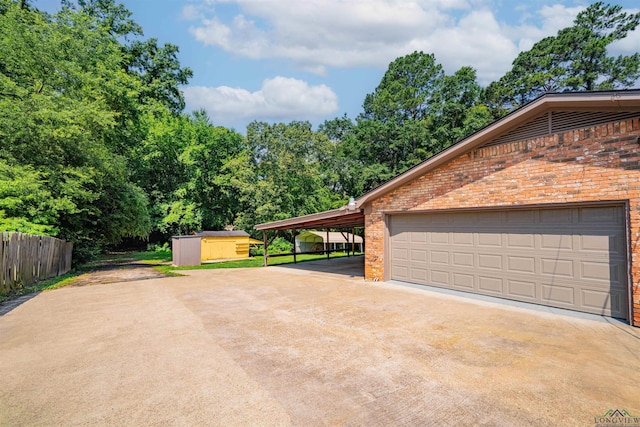 4525 Surratt Rd, Longview, TX 75604 - garage with concrete driveway and a storage unit