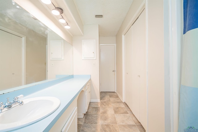 4525 Surratt Rd, Longview, TX 75604 - bathroom with vanity and a textured ceiling