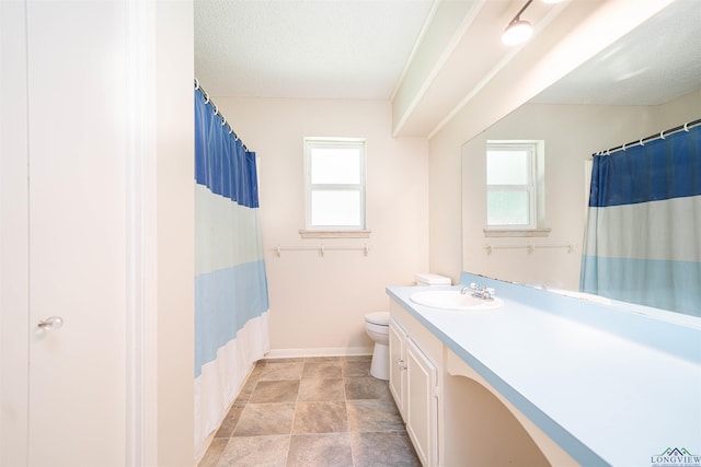 4525 Surratt Rd, Longview, TX 75604 - bathroom featuring vanity, toilet, baseboards, and a shower with curtain