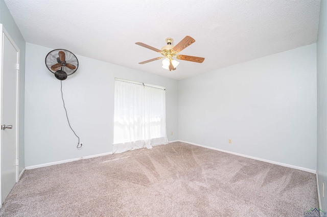 4525 Surratt Rd, Longview, TX 75604 - carpeted empty room featuring a ceiling fan, baseboards, and a textured ceiling