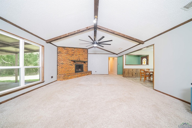 4525 Surratt Rd, Longview, TX 75604 - unfurnished living room featuring a ceiling fan, a textured ceiling, a fireplace, carpet, and crown molding
