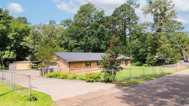 4525 Surratt Rd, Longview, TX 75604 - view of front facade with concrete driveway, a carport, and brick siding