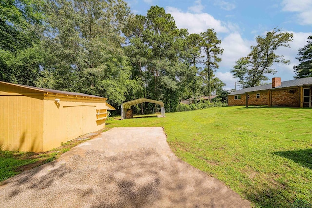 4525 Surratt Rd, Longview, TX 75604 - view of grassy yard with a carport and concrete driveway