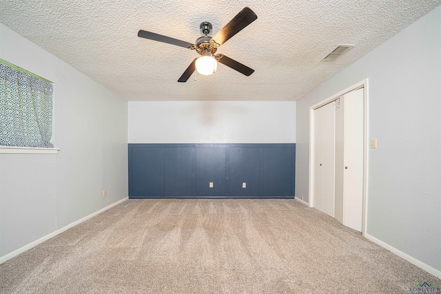 4525 Surratt Rd, Longview, TX 75604 - unfurnished bedroom featuring carpet floors, a textured ceiling, a ceiling fan, and a closet