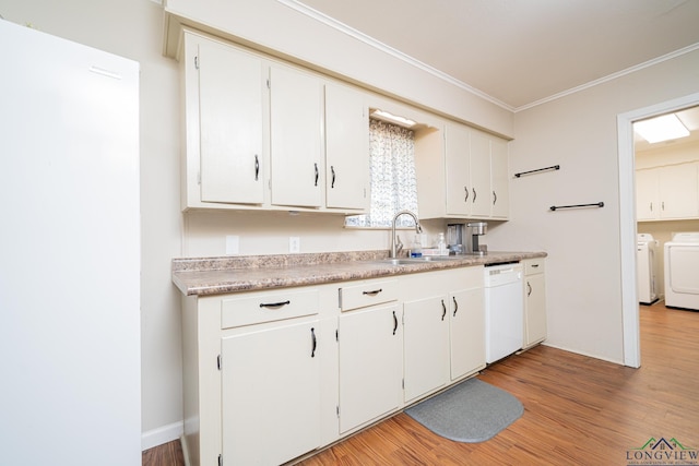 105 Sherwood Dr, Longview, TX 75605 - kitchen with independent washer and dryer, ornamental molding, a sink, light wood-style floors, and white dishwasher