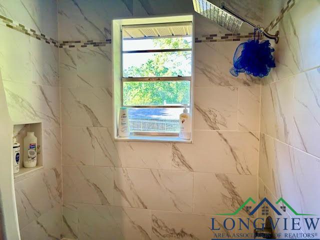interior space with tiled shower