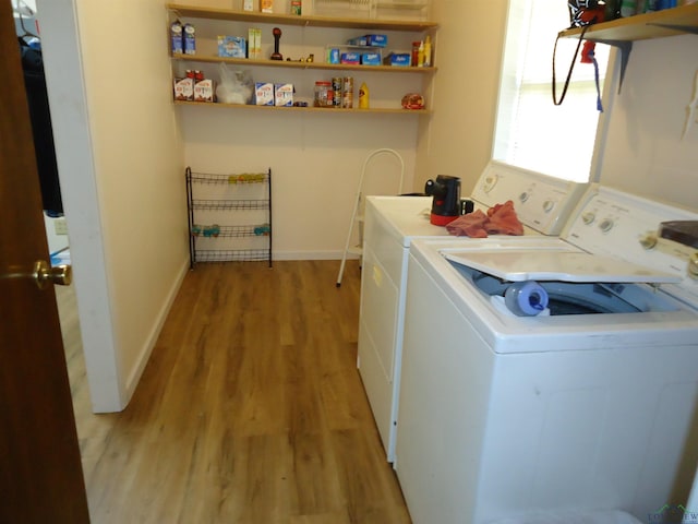 laundry room with laundry area, light wood-style flooring, baseboards, and separate washer and dryer