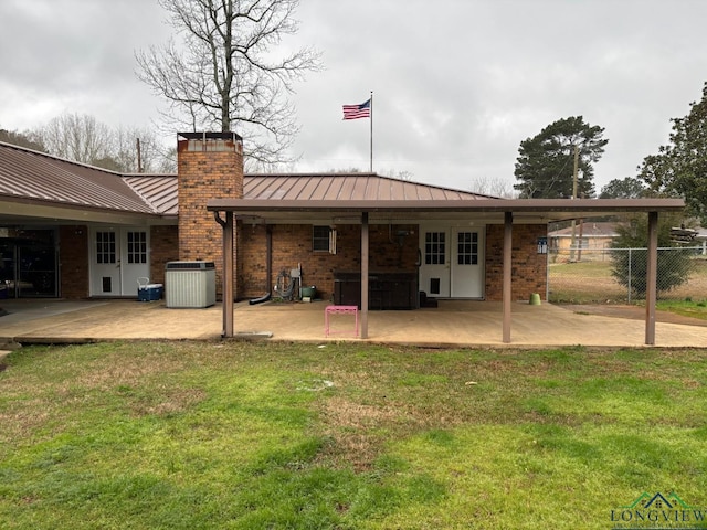 back of house with a patio, a standing seam roof, fence, french doors, and central air condition unit