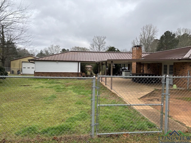 ranch-style house featuring brick siding, a chimney, a gate, fence, and metal roof