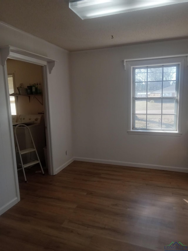 unfurnished room with baseboards and wood finished floors